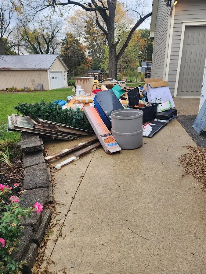 Dumpster being loaded with debris for 12 Yard Dumpster Rental in Haskell